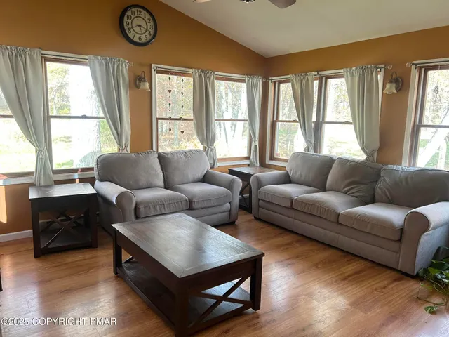 a living room with furniture and a large window