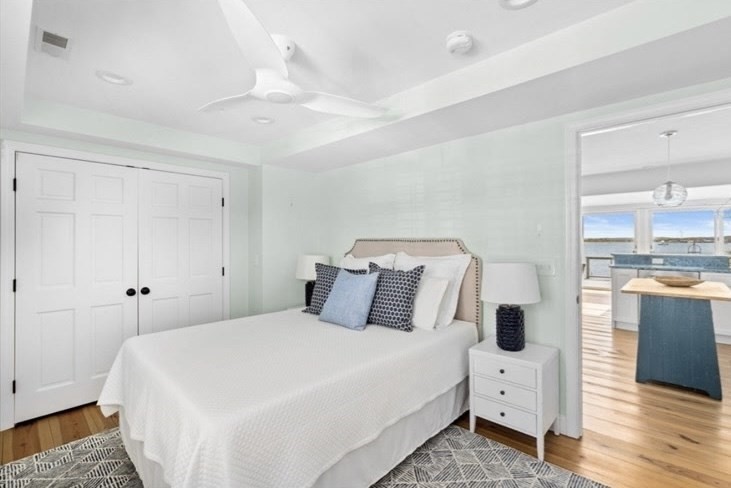 30 Lighthouse Road, Unit 30 Scituate, MA 02066 - Photo 9 of 18 a bedroom with a bed and wooden floor