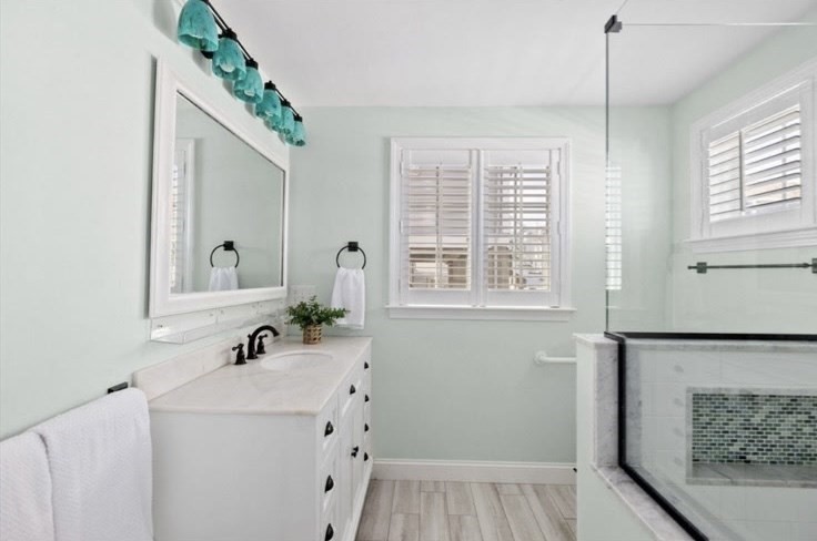30 Lighthouse Road, Unit 30 Scituate, MA 02066 - Photo 10 of 18 a bathroom with a sink a mirror and a window