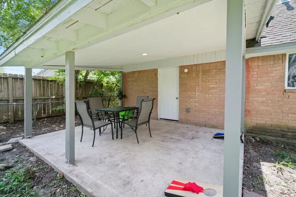 a view of a patio with a table and chairs