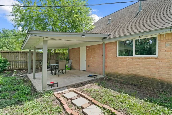 a backyard of a house with yard and outdoor seating