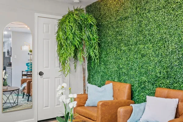 an outdoor living space with furniture and garden view