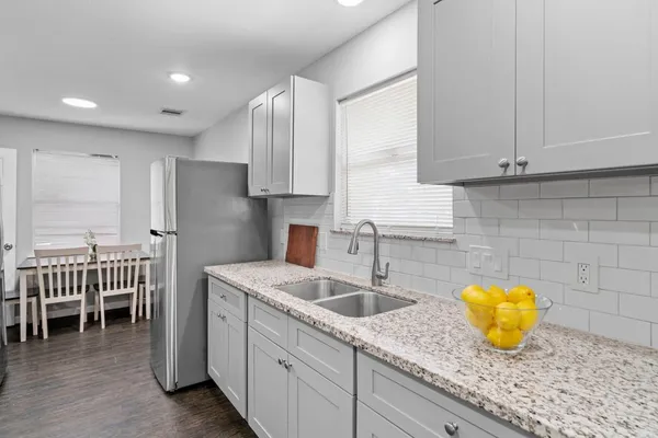 a kitchen with a sink and cabinets
