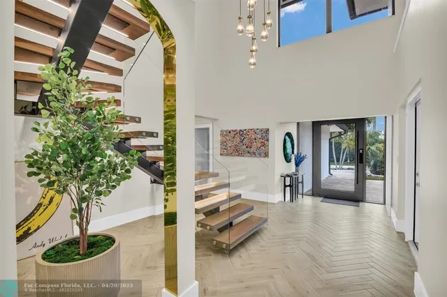 a dining room with furniture a chandelier and wooden floor