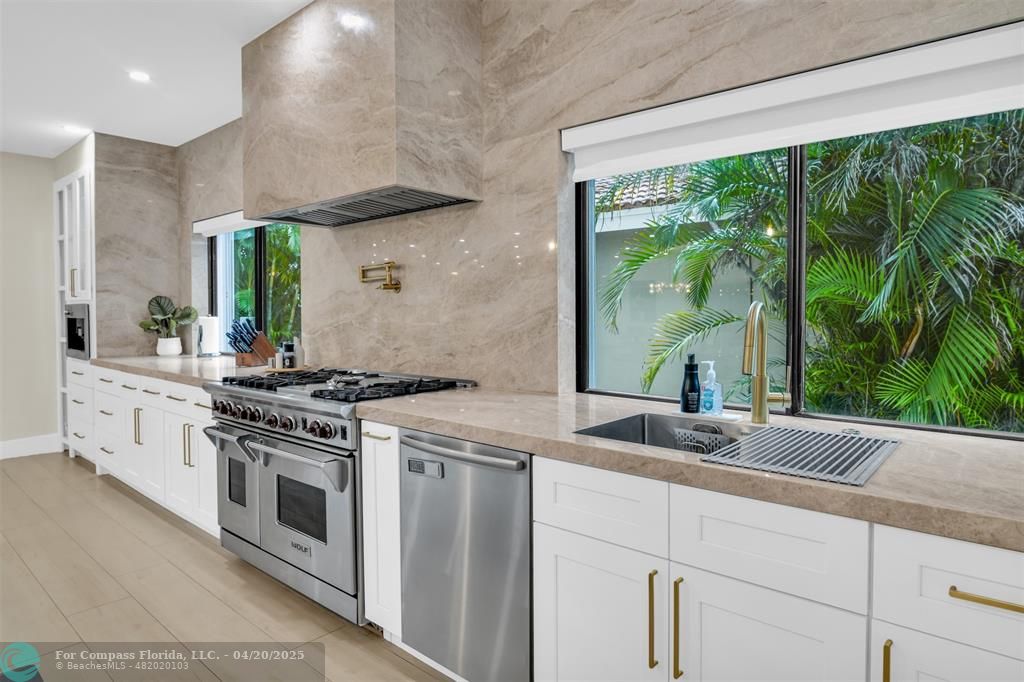 319 South Riverside Drive Pompano Beach, FL 33062 - Photo 16 of 98 a kitchen with a stove and a sink