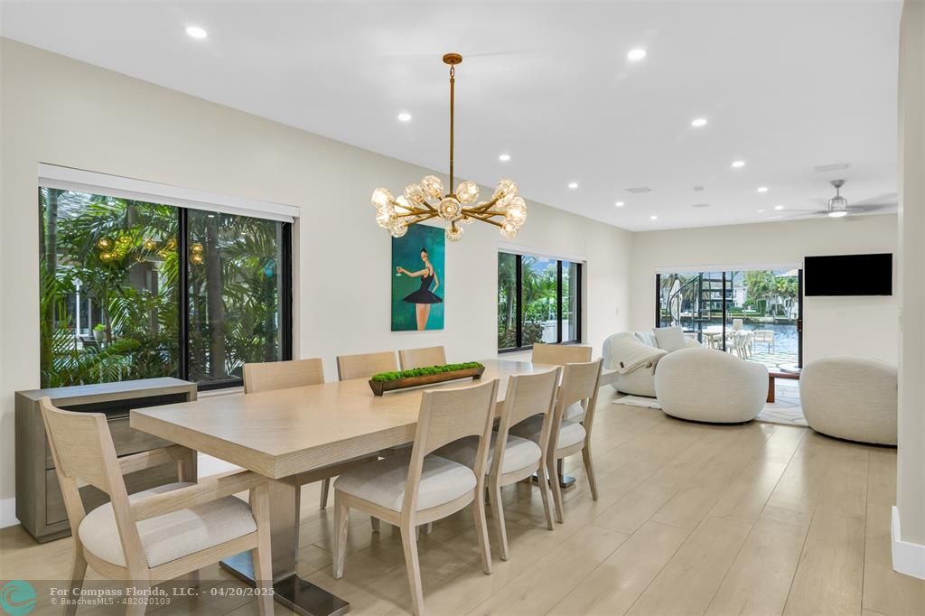 319 South Riverside Drive Pompano Beach, FL 33062 - Photo 22 of 98 a dining room with furniture a chandelier and wooden floor