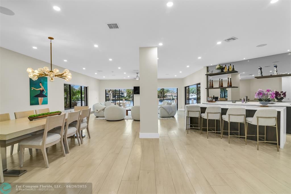 319 South Riverside Drive Pompano Beach, FL 33062 - Photo 23 of 98 a large kitchen with a table and chairs in it