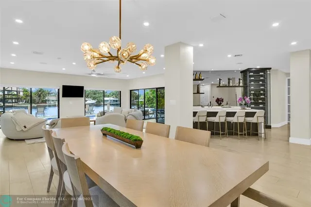 a very nice looking living room with a large window and a chandelier