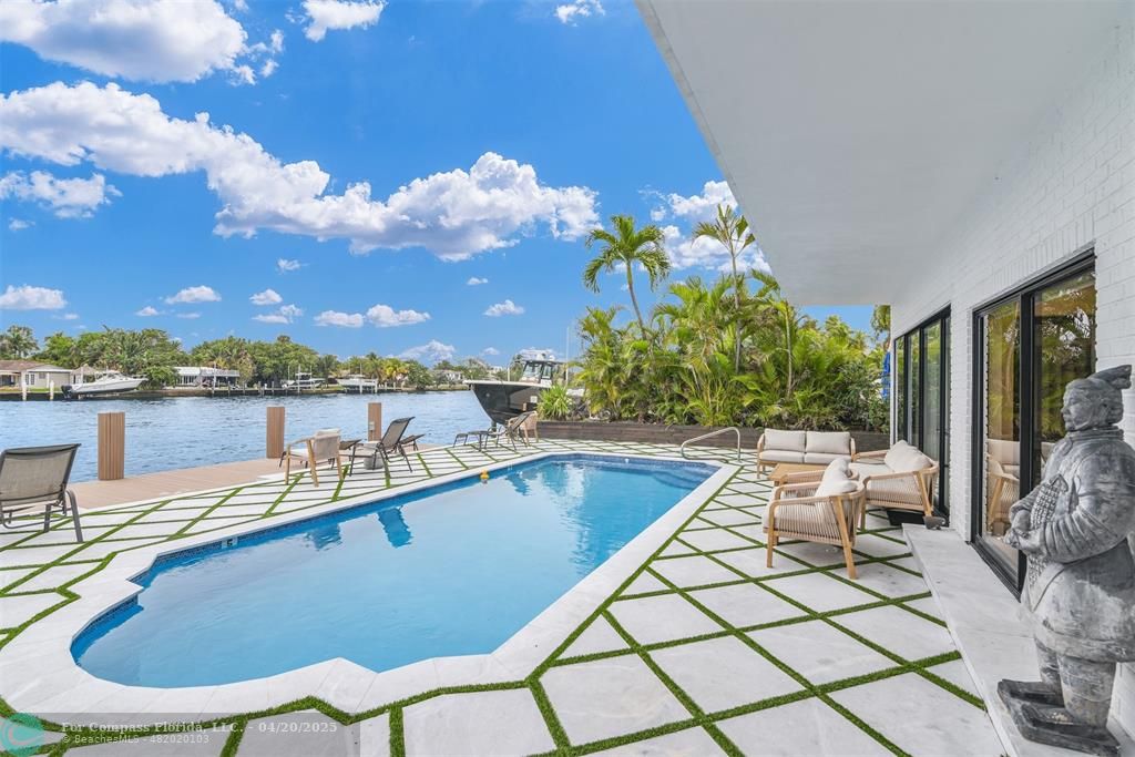 319 South Riverside Drive Pompano Beach, FL 33062 - Photo 32 of 98 a view of a swimming pool and lounge chairs