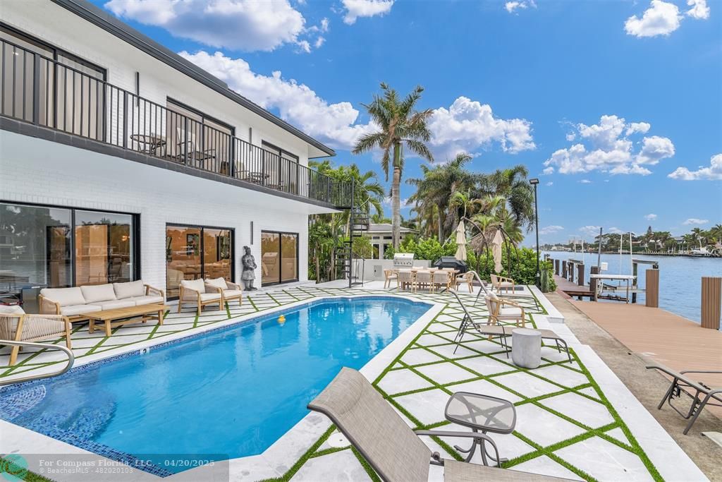 319 South Riverside Drive Pompano Beach, FL 33062 - Photo 36 of 98 a view of a house with swimming pool and sitting area