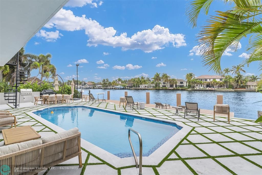 319 South Riverside Drive Pompano Beach, FL 33062 - Photo 37 of 98 a view of a swimming pool with outdoor seating and city view