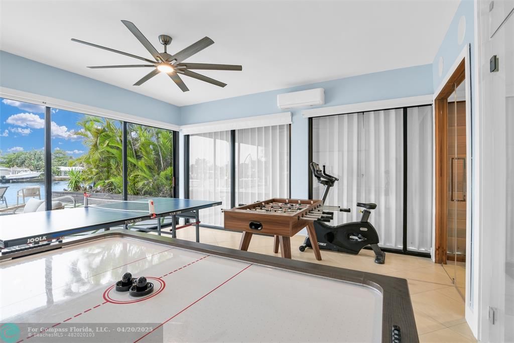 319 South Riverside Drive Pompano Beach, FL 33062 - Photo 44 of 98 a very nice looking living room with a large window and a chandelier