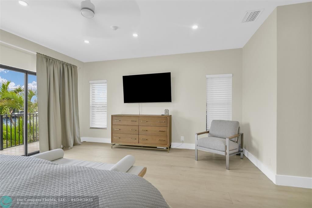 319 South Riverside Drive Pompano Beach, FL 33062 - Photo 67 of 98 a bedroom with furniture and a flat screen tv