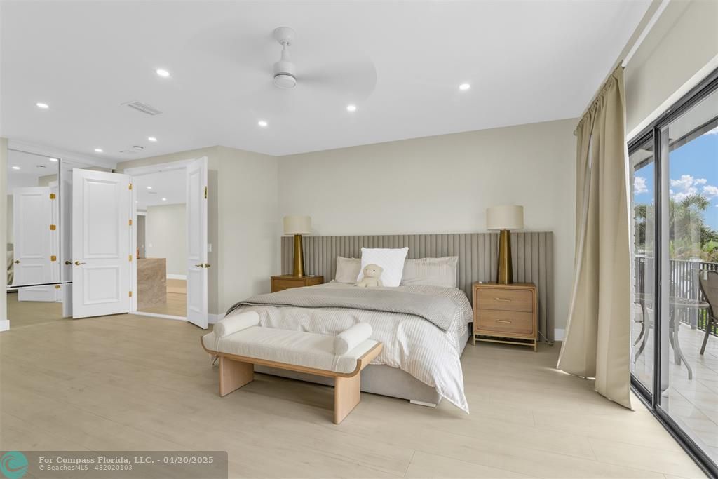 319 South Riverside Drive Pompano Beach, FL 33062 - Photo 68 of 98 a spacious bedroom with a bed and a large mirror