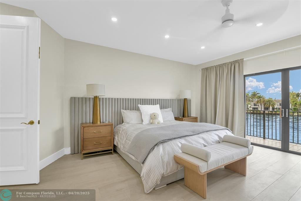 319 South Riverside Drive Pompano Beach, FL 33062 - Photo 69 of 98 a spacious bedroom with a bed and a large window