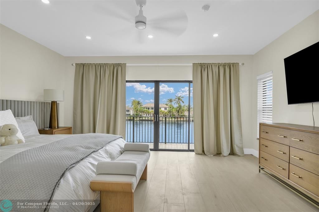 319 South Riverside Drive Pompano Beach, FL 33062 - Photo 70 of 98 a bedroom with a bed and a flat screen tv