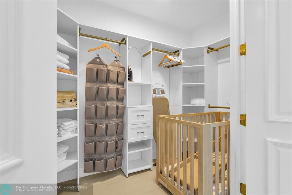 319 South Riverside Drive Pompano Beach, FL 33062 - Photo 71 of 98 a view of walk in closet with clothes and shoes