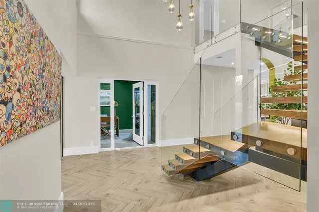 a kitchen with stainless steel appliances a sink a stove a chimney a sink and cabinets