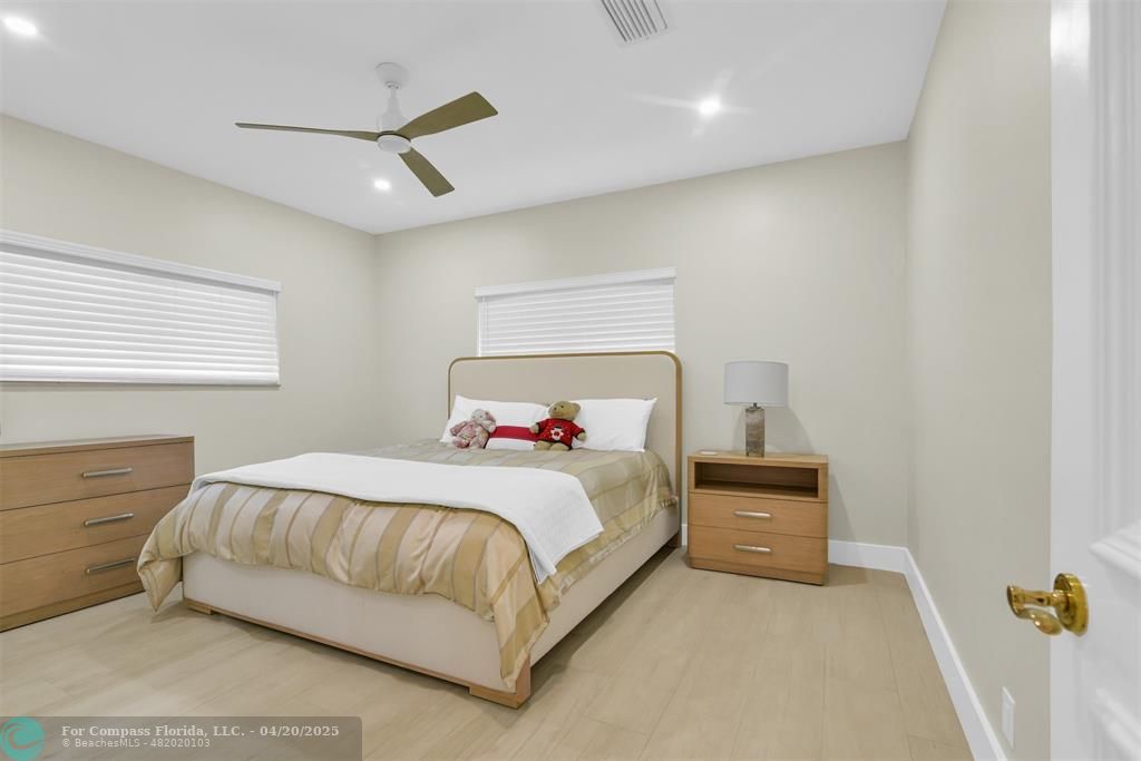 319 South Riverside Drive Pompano Beach, FL 33062 - Photo 82 of 98 a bedroom with a bed and a window
