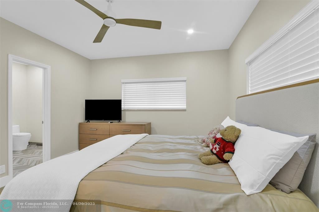 319 South Riverside Drive Pompano Beach, FL 33062 - Photo 83 of 98 a bedroom with a bed and a tv