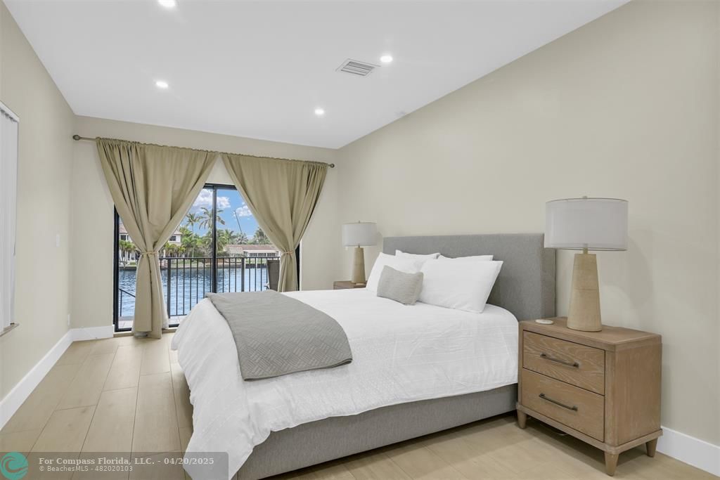 319 South Riverside Drive Pompano Beach, FL 33062 - Photo 85 of 98 a bedroom with a large bed and a window