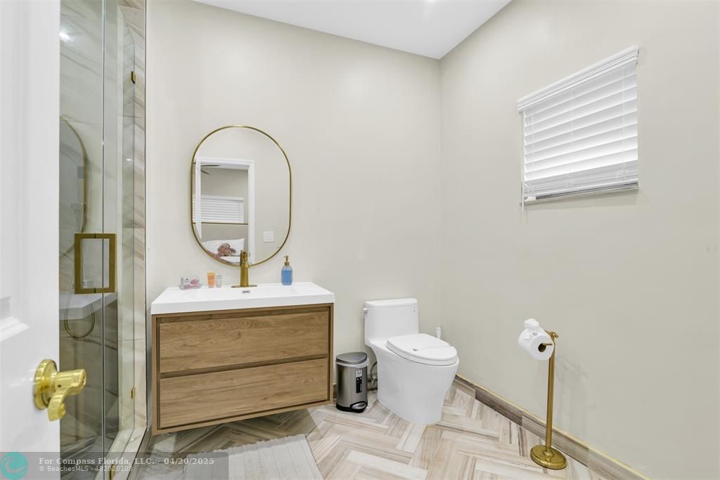 319 South Riverside Drive Pompano Beach, FL 33062 - Photo 86 of 98 a bathroom with a sink toilet and mirror