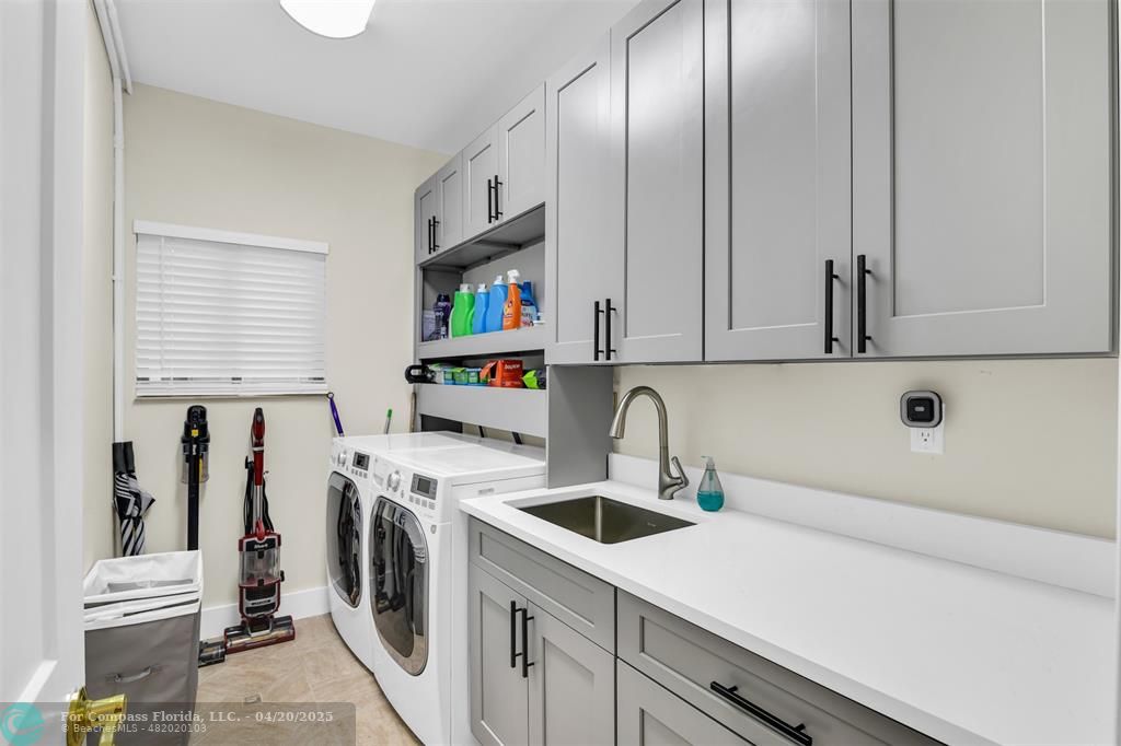 319 South Riverside Drive Pompano Beach, FL 33062 - Photo 88 of 98 a kitchen with a sink a stove and cabinets
