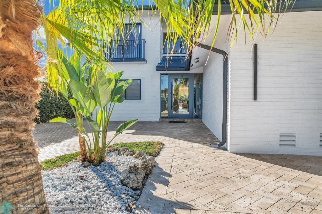 319 South Riverside Drive Pompano Beach, FL 33062 - Photo 95 of 98 a front view of a house with a yard
