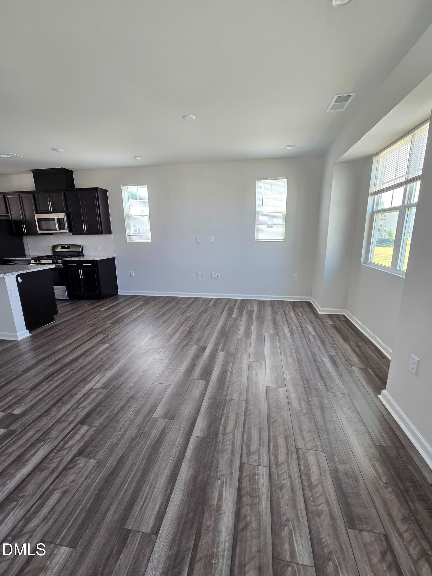 2431 Kasota Lane Raleigh, NC 27610 - Photo 18 of 46 wooden floor in an empty room with a window