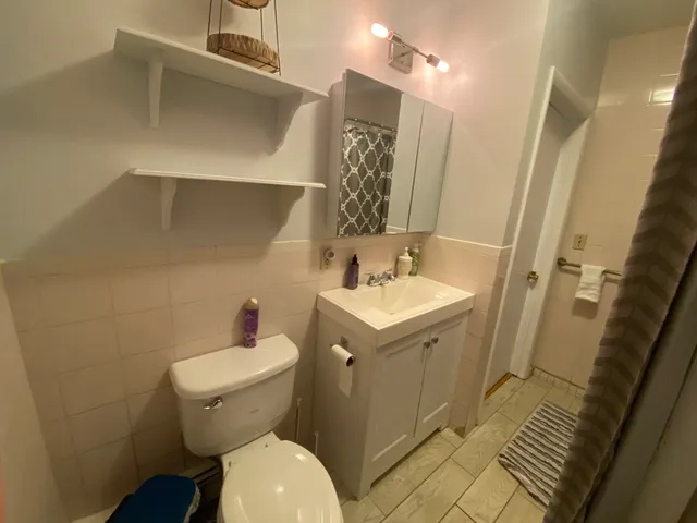 a bathroom with a sink toilet and shower