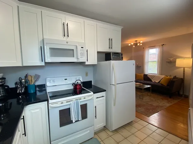 a kitchen with refrigerator and cabinets