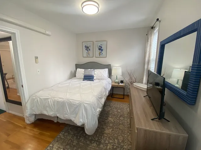 a bedroom with a bed and a mirror