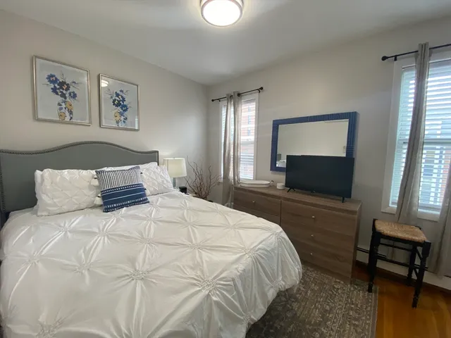 a bedroom with a bed and a television