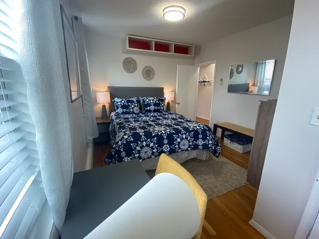 a bed room with a bed and a window