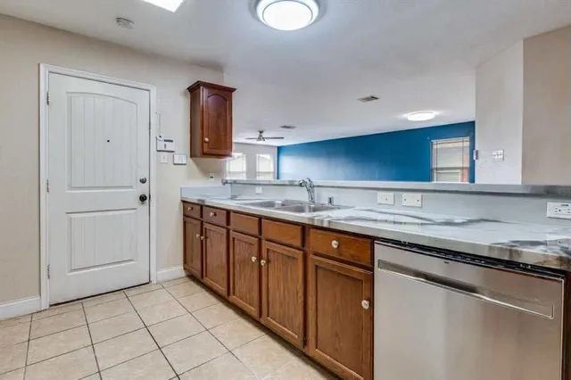 a kitchen with stainless steel appliances granite countertop a sink and a stove