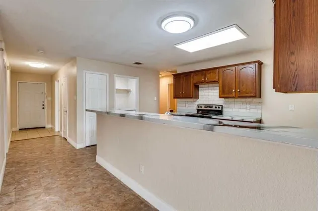 a view of a kitchen with a sink and cabinets