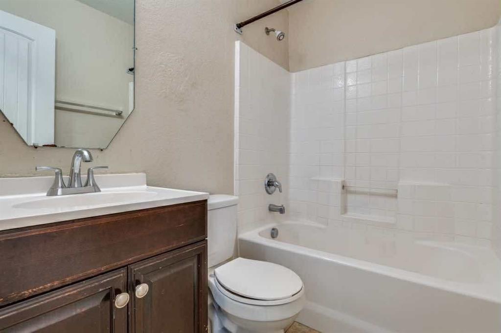 2118 Augusta Street Lancaster, TX 75146 - Photo 21 of 25 a bathroom with a sink a toilet and bathtub