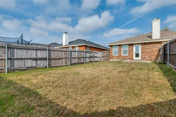 a view of a house with a yard and sitting area