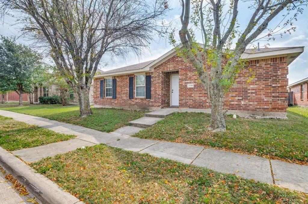 2118 Augusta Street Lancaster, TX 75146 - Photo 3 of 25 a front view of a house with a yard and garage