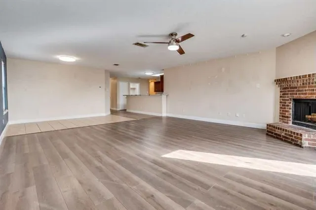 wooden floor in an empty room with a fireplace