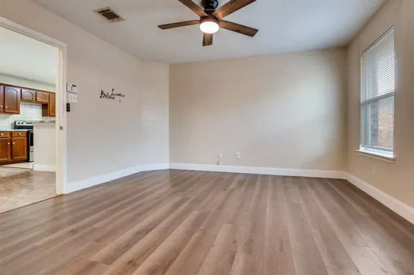 wooden floor in an empty room with a window