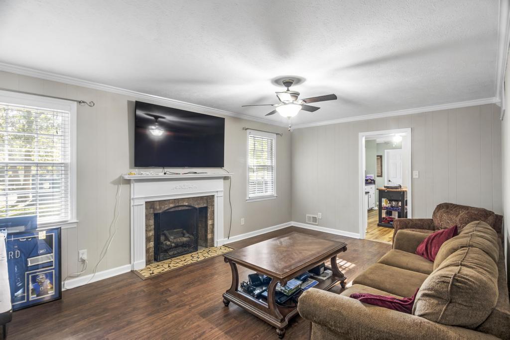 1934 Huntsman Drive Aiken, SC 29803 - Photo 11 of 19 a living room with furniture a flat screen tv and a fireplace