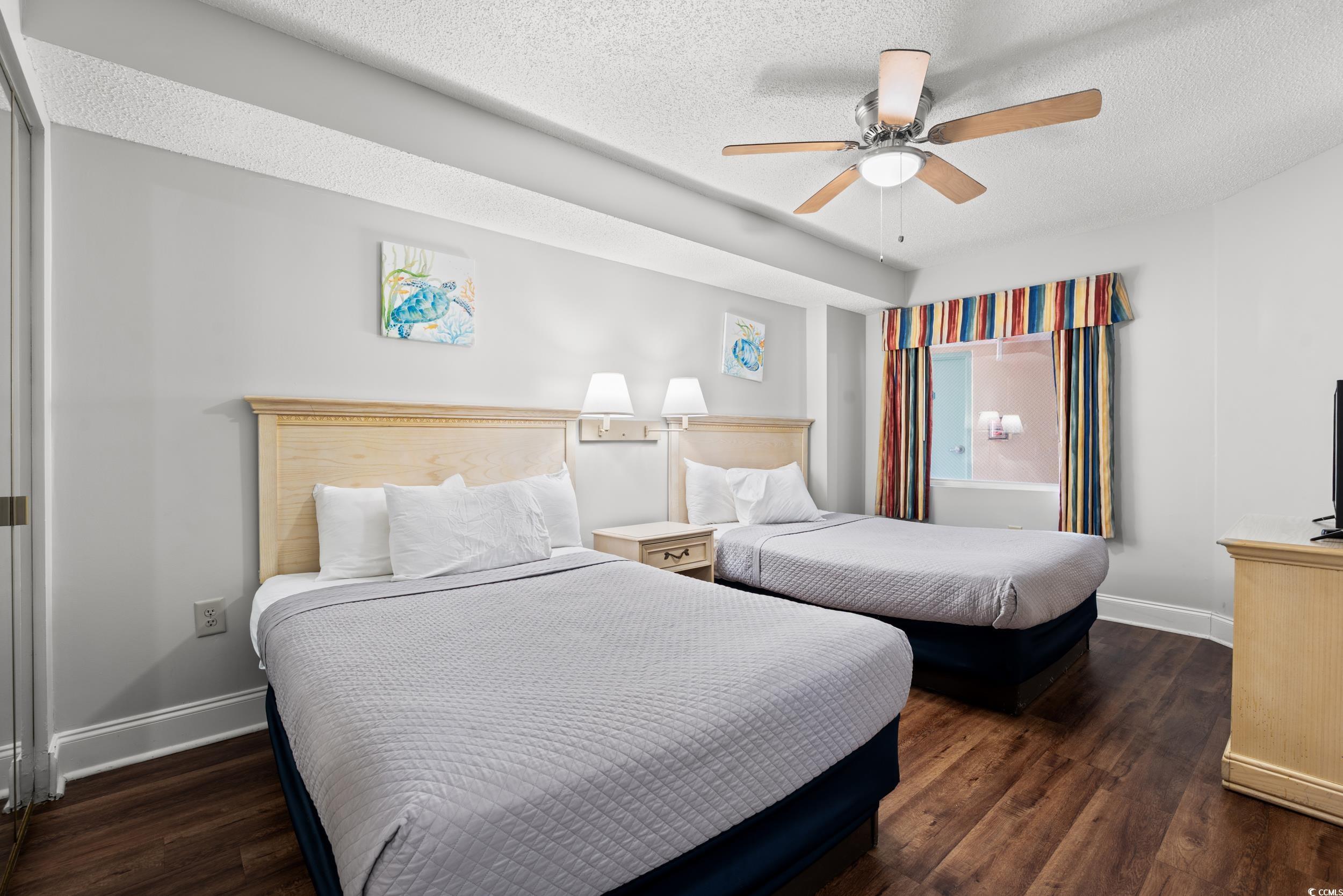 201N 74th Avenue North, Unit 601 Myrtle Beach, SC 29572 - Photo 14 of 35 Bedroom featuring a textured ceiling, dark wood finished floors, and a ceiling fan