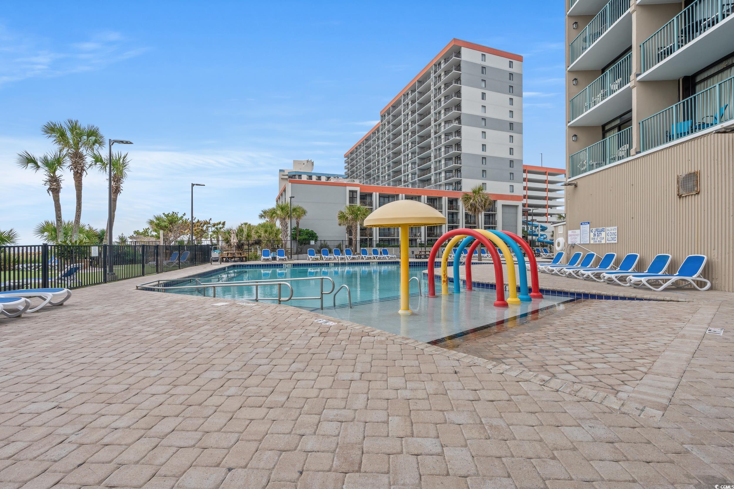 201N 74th Avenue North, Unit 601 Myrtle Beach, SC 29572 - Photo 23 of 35 Community pool with a water play area and a patio