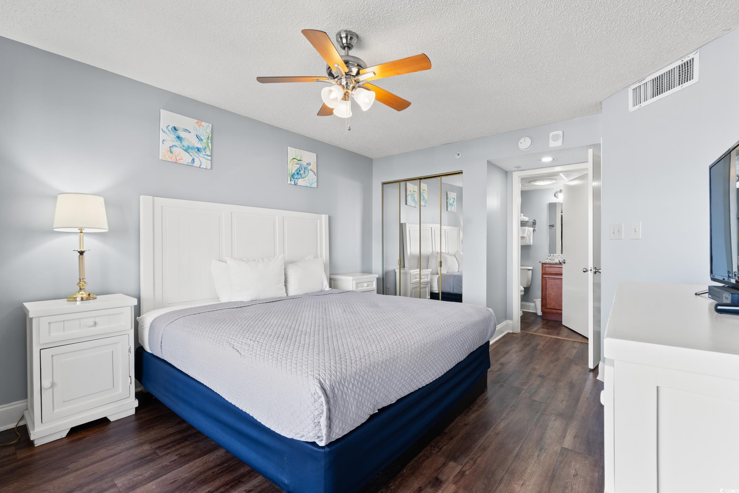 201N 74th Avenue North, Unit 601 Myrtle Beach, SC 29572 - Photo 9 of 35 Bedroom with a closet, dark wood-type flooring, a textured ceiling, and ceiling fan