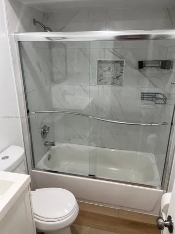 a bathroom with a bathtub and a toilet