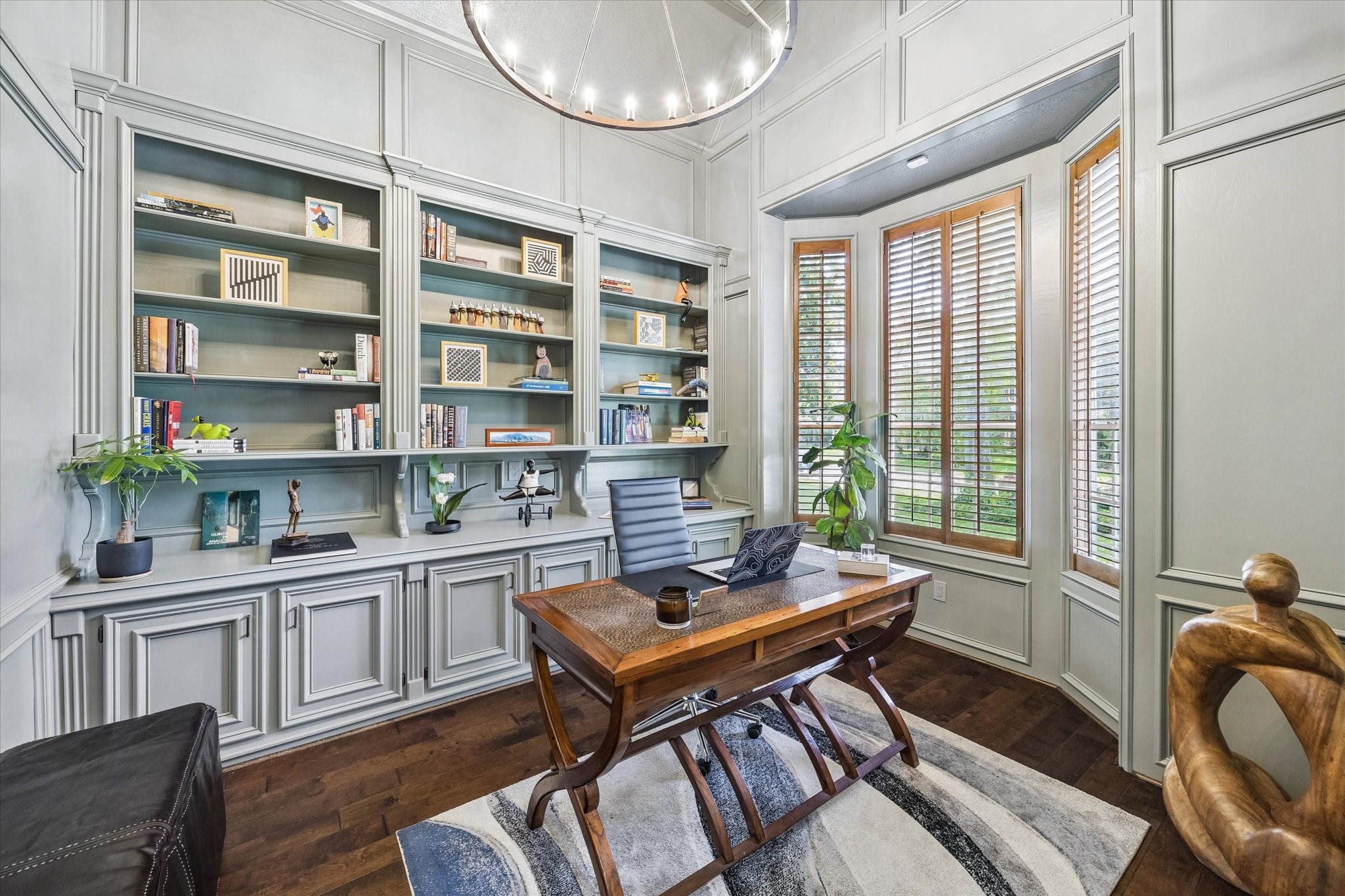 146 Golden Shadow Circle Spring, TX 77381 - Photo 7 of 41 Dedicated study painted in a designer palette of Evergreen Fog with vintage lighting, built-in bookcases, and custom cabinetry. French doors provide privacy, while the bay window offers beautiful views of the front yard.
