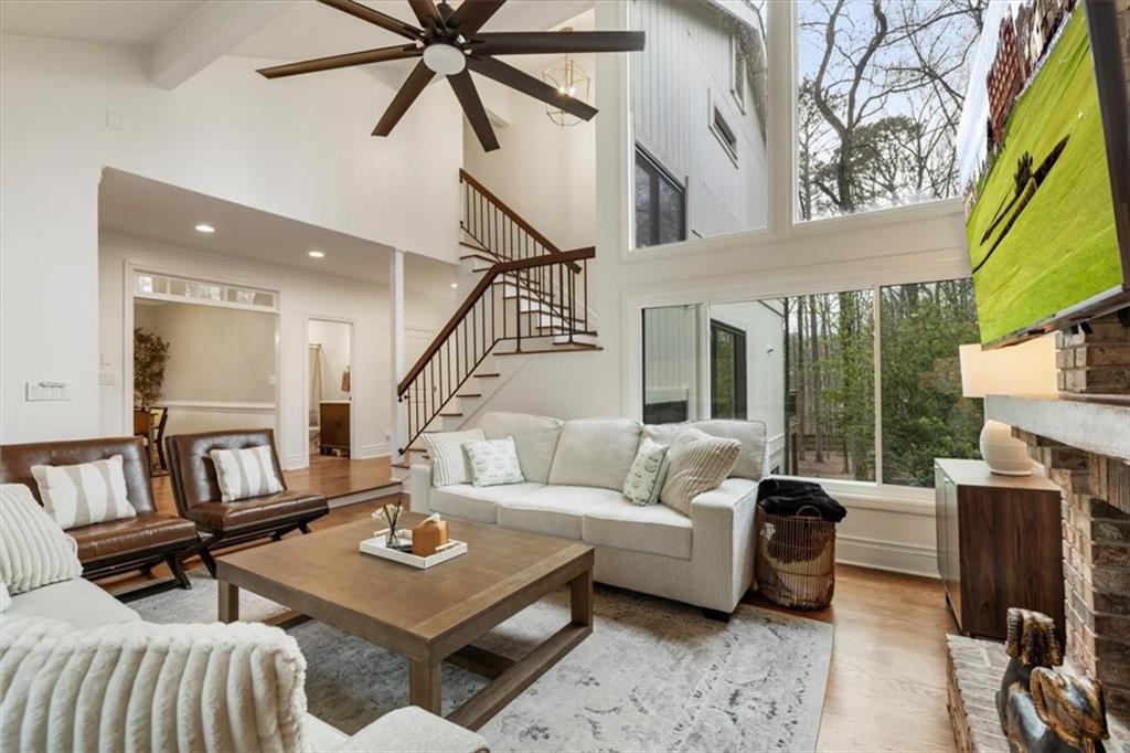 a living room with furniture and a floor to ceiling window