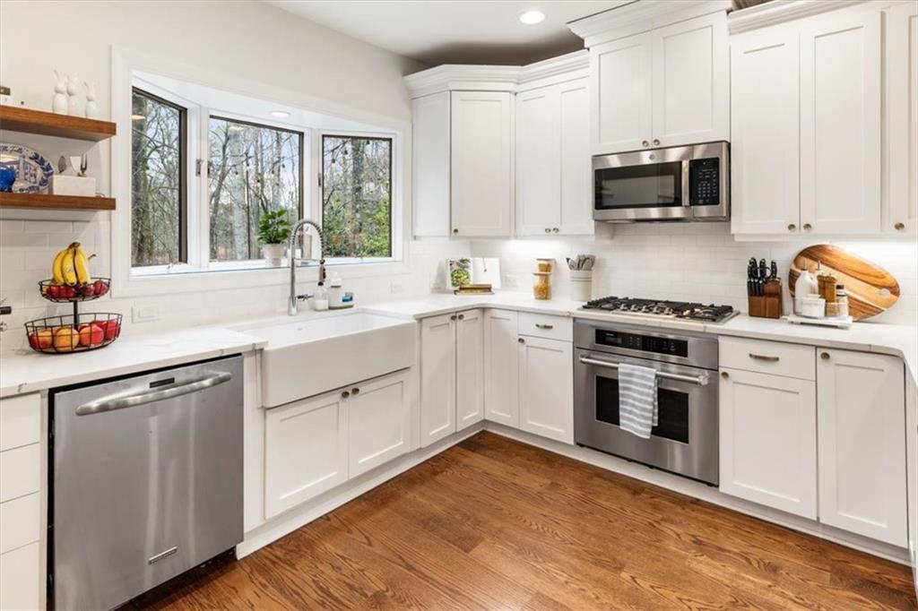2415 Roxburgh Drive Roswell, GA 30076 - Photo 19 of 62 a kitchen with white cabinets appliances a sink and a window