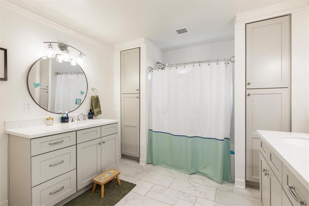 2415 Roxburgh Drive Roswell, GA 30076 - Photo 36 of 62 a bathroom with a sink a toilet and a mirror